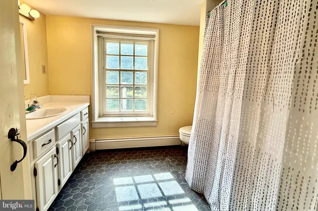 a bathroom with a bathtub a sink and a window