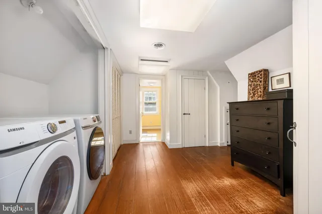 a view of walk in closet with window and washer