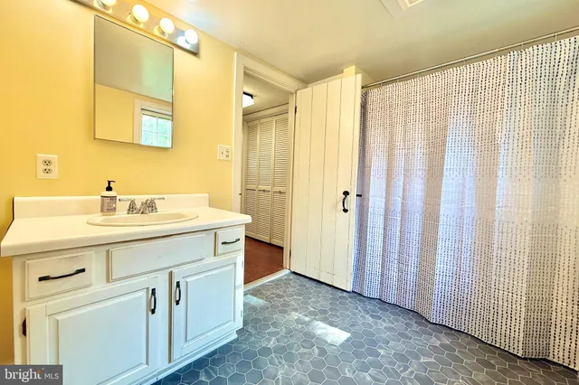 a bathroom with a double vanity sink and mirror