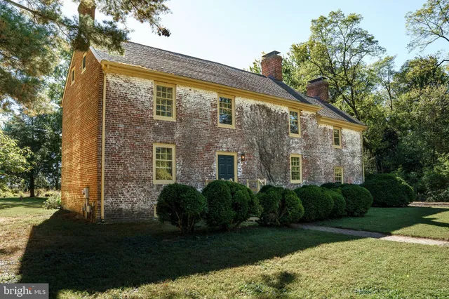 a view of a brick house with a yard