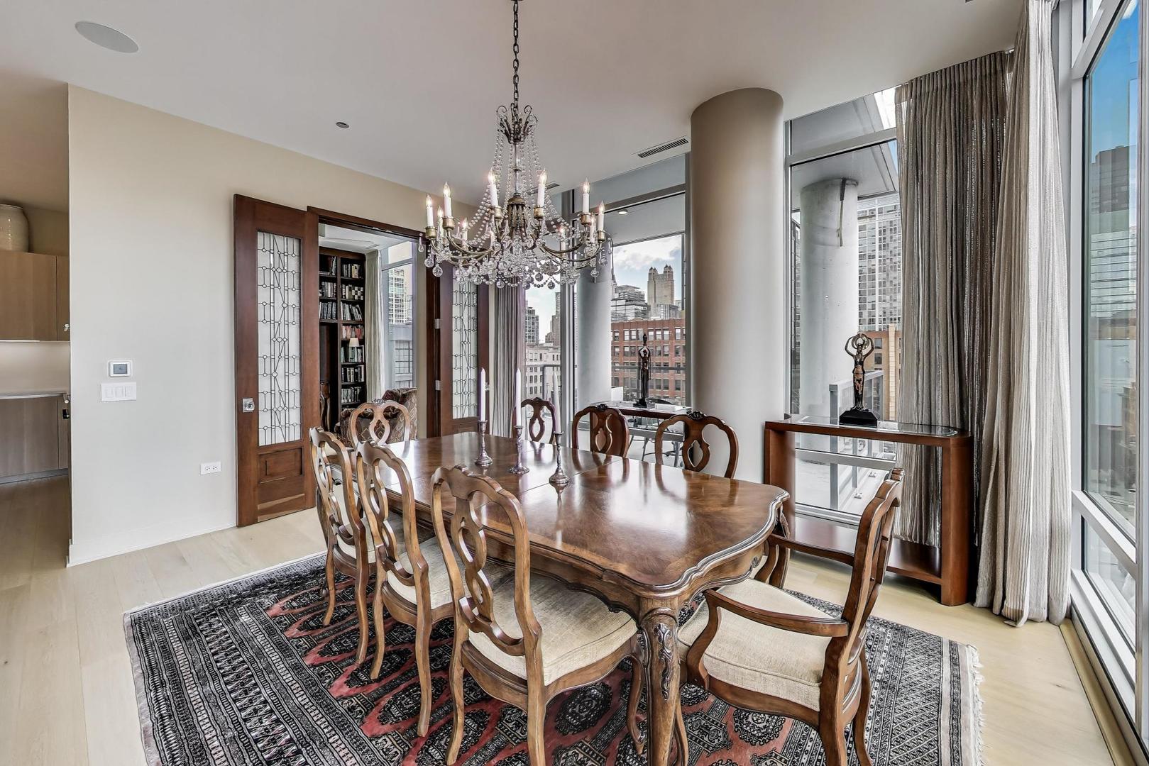 360 West Erie Street, Unit 7D Chicago, IL 60654 - Photo 14 of 39 a view of a dining room with furniture and chandelier