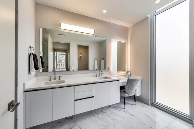 a bathroom with a double vanity sink and a mirror