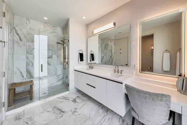 a bathroom with a double vanity sink mirror and shower