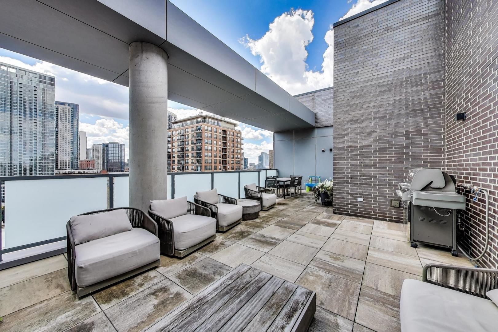 360 West Erie Street, Unit 7D Chicago, IL 60654 - Photo 37 of 39 a living room with furniture and a fireplace