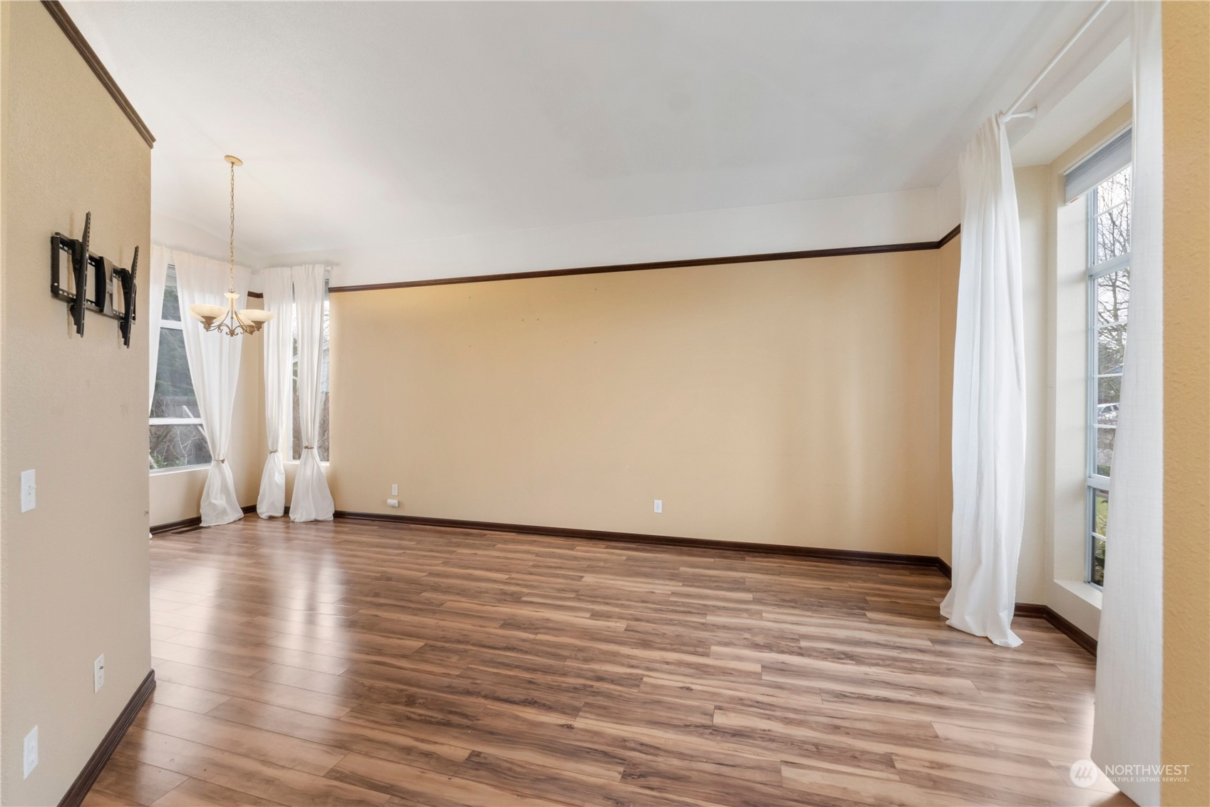 3534 Crystal Ridge Drive Southeast Puyallup, WA 98372 - Photo 14 of 39 a view of an empty room with wooden floor and a window