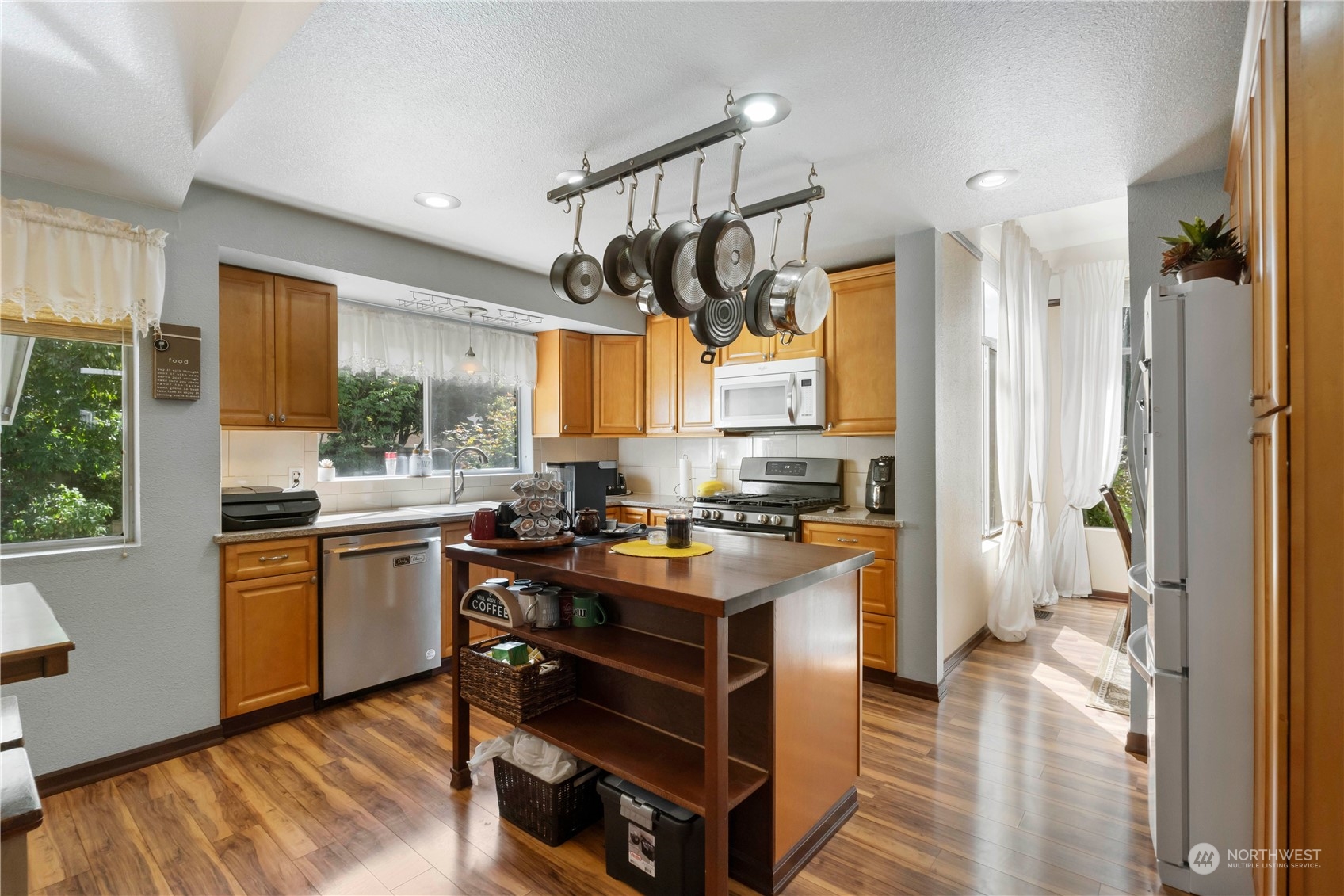 3534 Crystal Ridge Drive Southeast Puyallup, WA 98372 - Photo 18 of 39 a kitchen with a sink appliances cabinets and a wooden floor