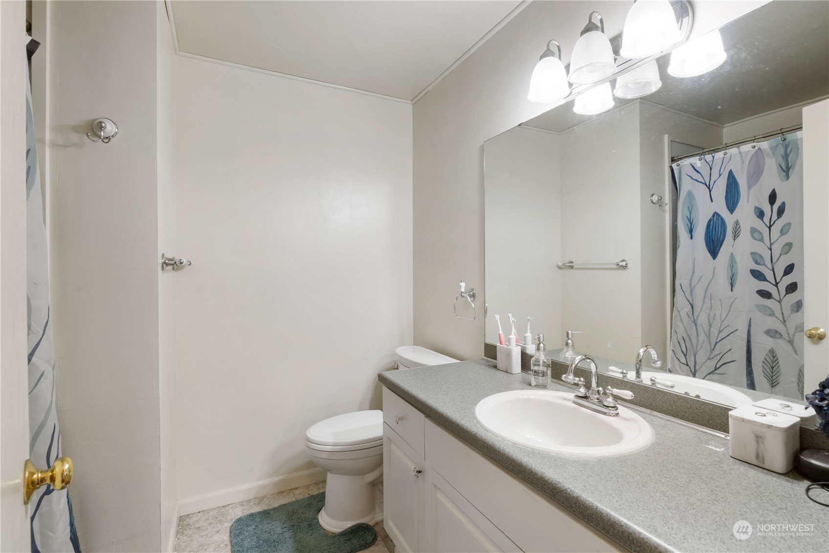 3534 Crystal Ridge Drive Southeast Puyallup, WA 98372 - Photo 23 of 39 a bathroom with a toilet sink and mirror