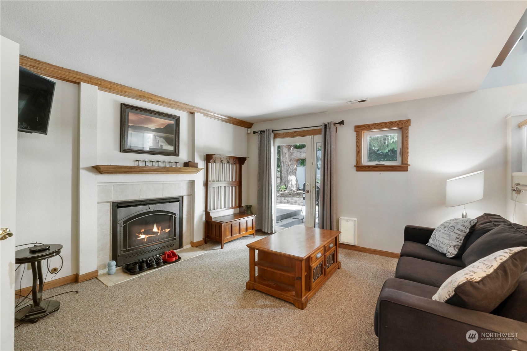 3534 Crystal Ridge Drive Southeast Puyallup, WA 98372 - Photo 27 of 39 a living room with furniture and a fireplace