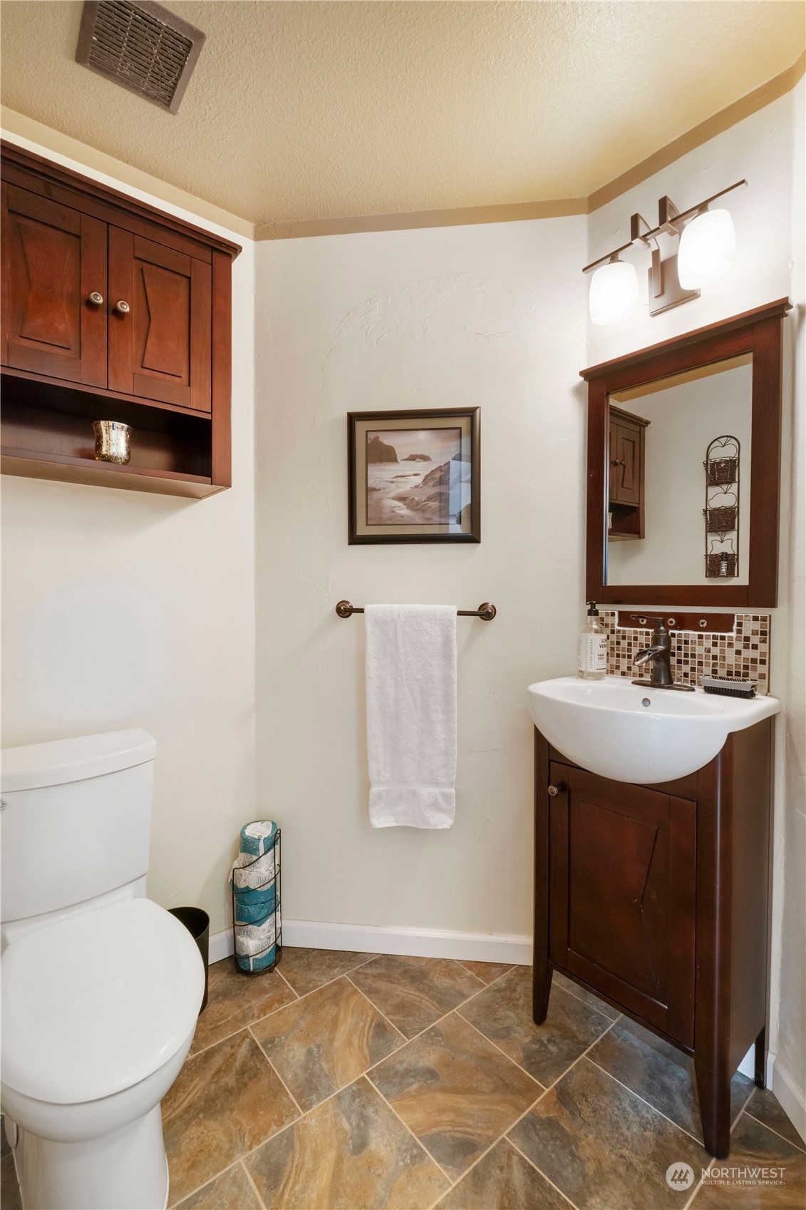 3534 Crystal Ridge Drive Southeast Puyallup, WA 98372 - Photo 28 of 39 a bathroom with a toilet sink and mirror