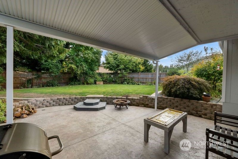 3534 Crystal Ridge Drive Southeast Puyallup, WA 98372 - Photo 32 of 39 a view of a patio with table and chairs potted plants with floor to ceiling window