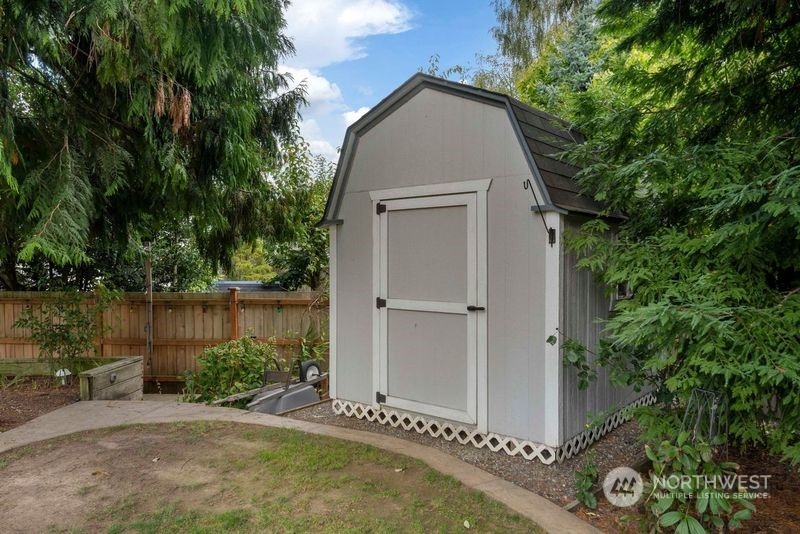 3534 Crystal Ridge Drive Southeast Puyallup, WA 98372 - Photo 34 of 39 a view of a house with a yard and a large tree
