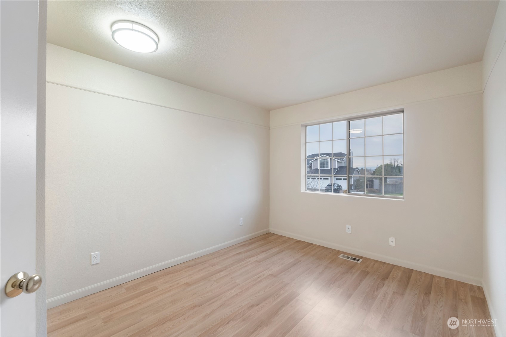 3534 Crystal Ridge Drive Southeast Puyallup, WA 98372 - Photo 5 of 39 an empty room with wooden floor and windows