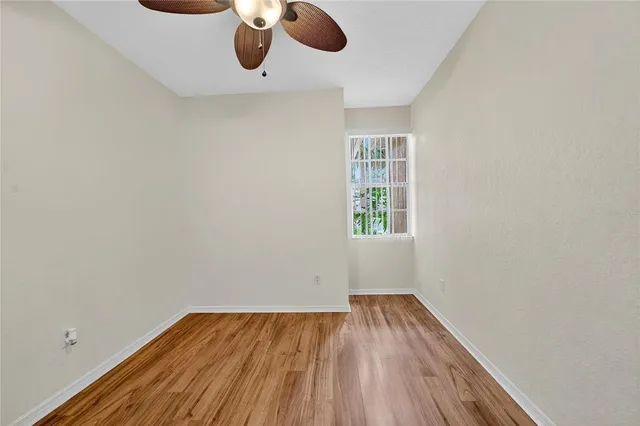 a view of walk in closet with empty racks