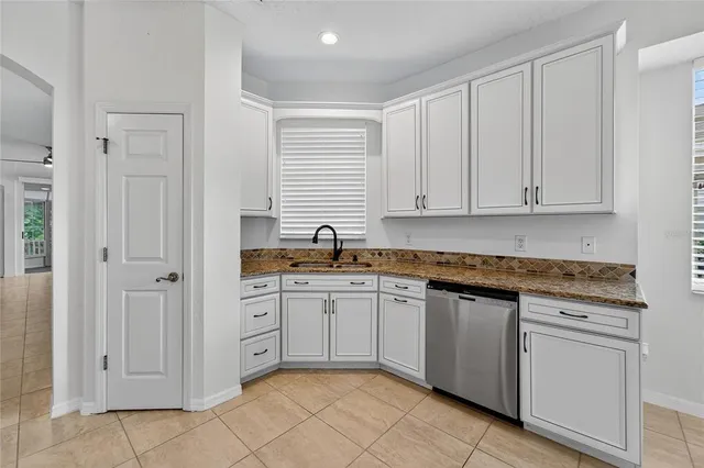 a kitchen with white cabinets