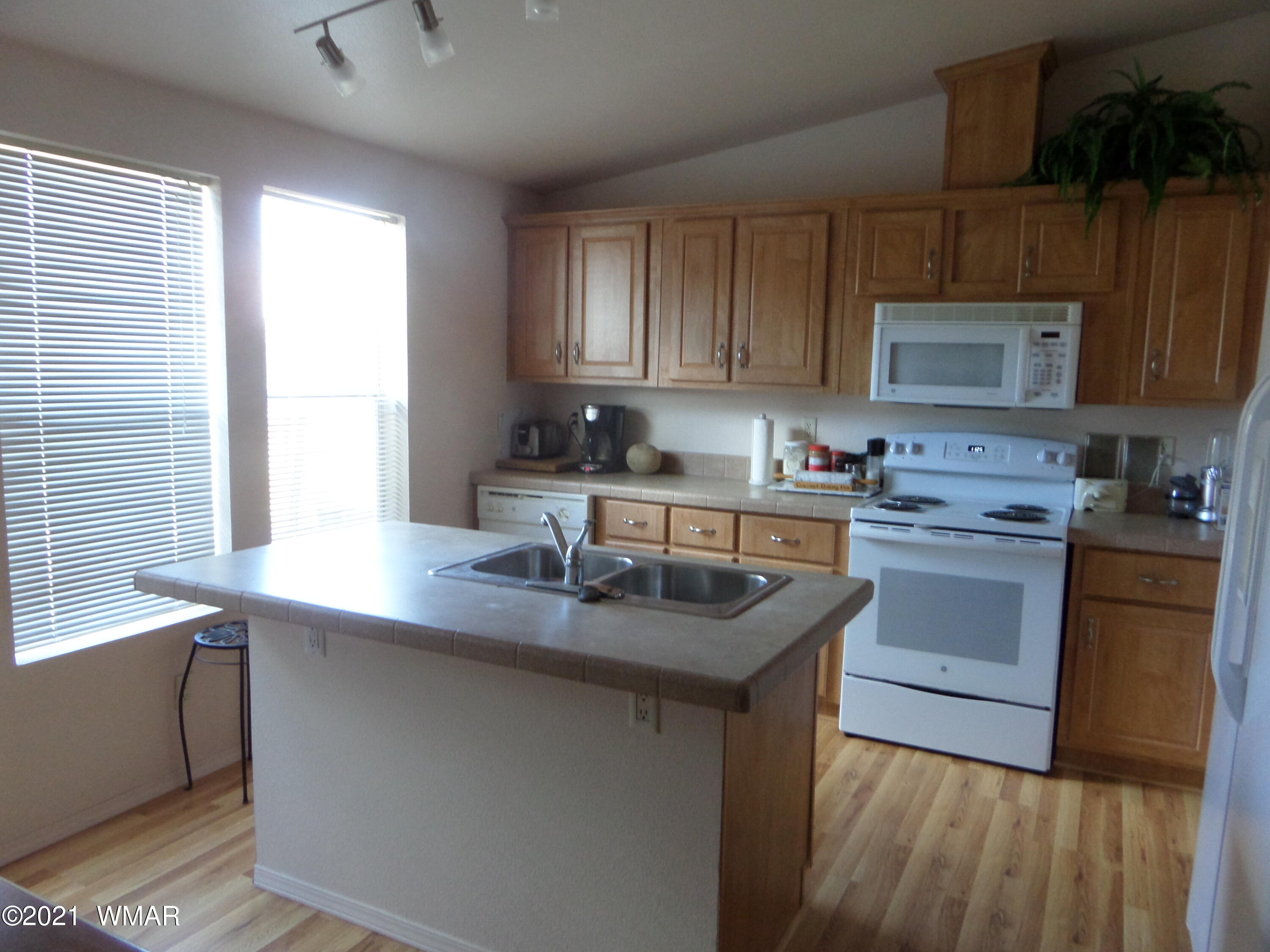 5 County Road Show Low, AZ 85901 - Photo 6 of 23 a kitchen with a sink stove and cabinets