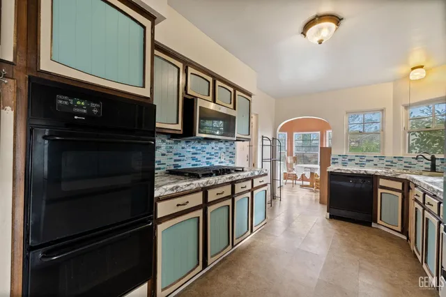 a kitchen with stainless steel appliances granite countertop a stove and a refrigerator
