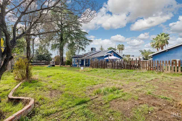 a view of a house with pool and a yard