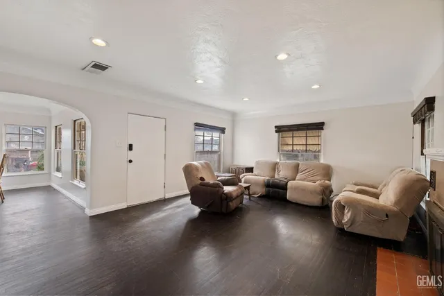 a living room with furniture window and wooden floor