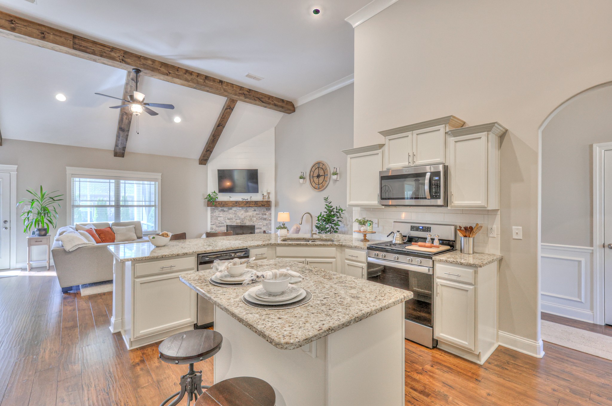 1011 Licinius Lane Murfreesboro, TN 37128 - Photo 11 of 31 a kitchen with a stove a sink dishwasher a dining table and chairs with wooden floor