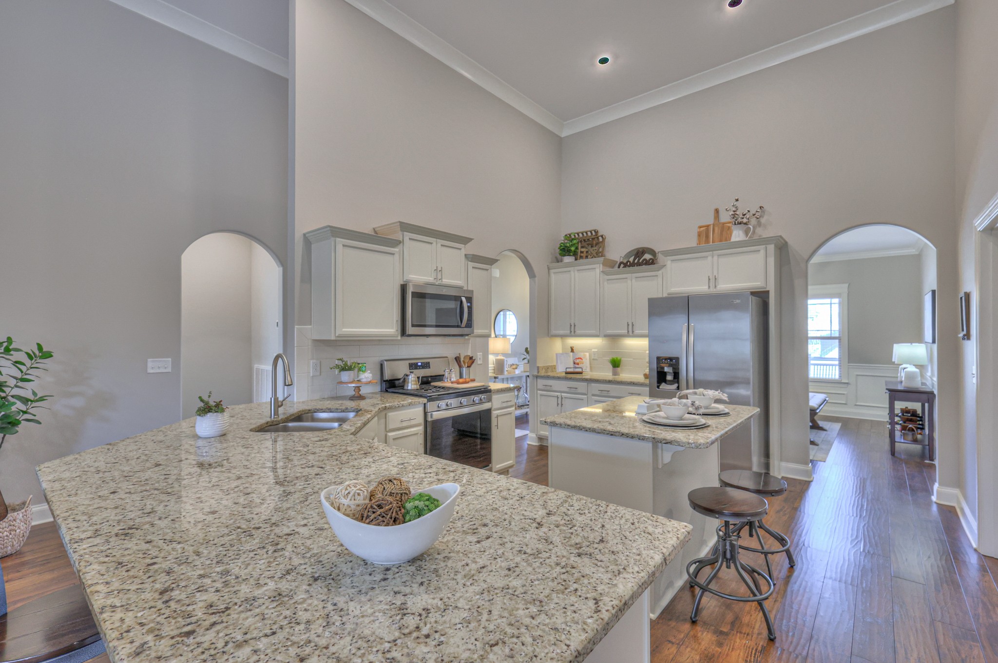 1011 Licinius Lane Murfreesboro, TN 37128 - Photo 10 of 31 a kitchen with stainless steel appliances granite countertop a stove top oven a sink a dining table and chairs with wooden floor