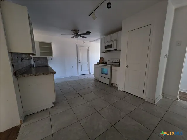 a kitchen with granite countertop cabinets and steel stainless steel appliances