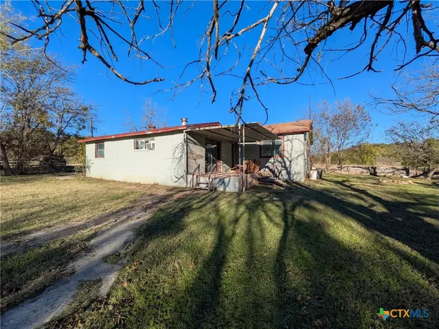 a view of a swimming pool with a yard