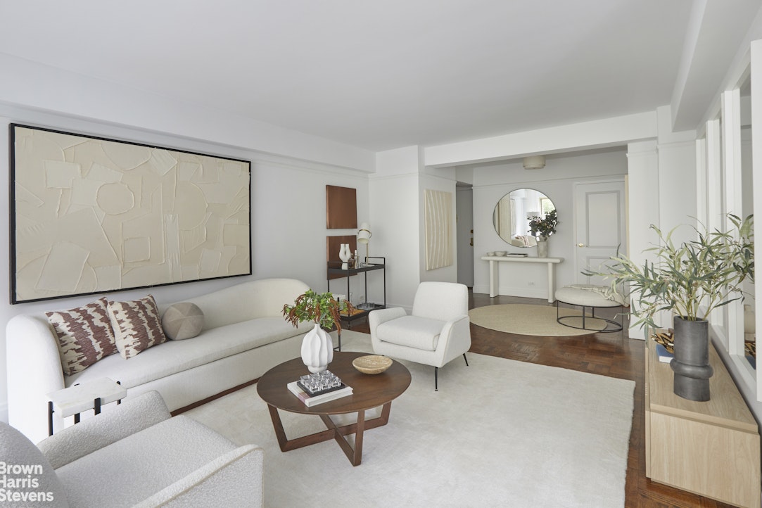 415 East 52nd Street, Unit 3EC Manhattan, NY 10022 - Photo 3 of 12 a living room with furniture and wooden floor
