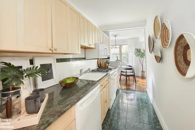 a kitchen with stainless steel appliances granite countertop a sink a stove and a wooden floors