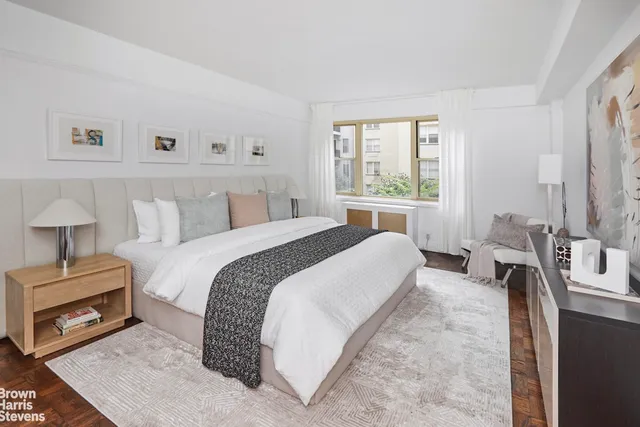 a bedroom with a bed and a tv