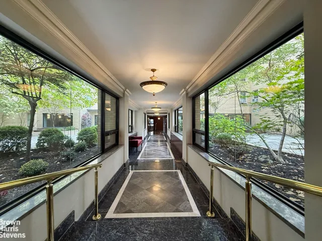 a view of a room with wooden floor and furniture