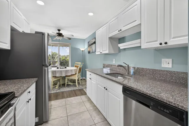 a dining room with furniture a chandelier and wooden floor