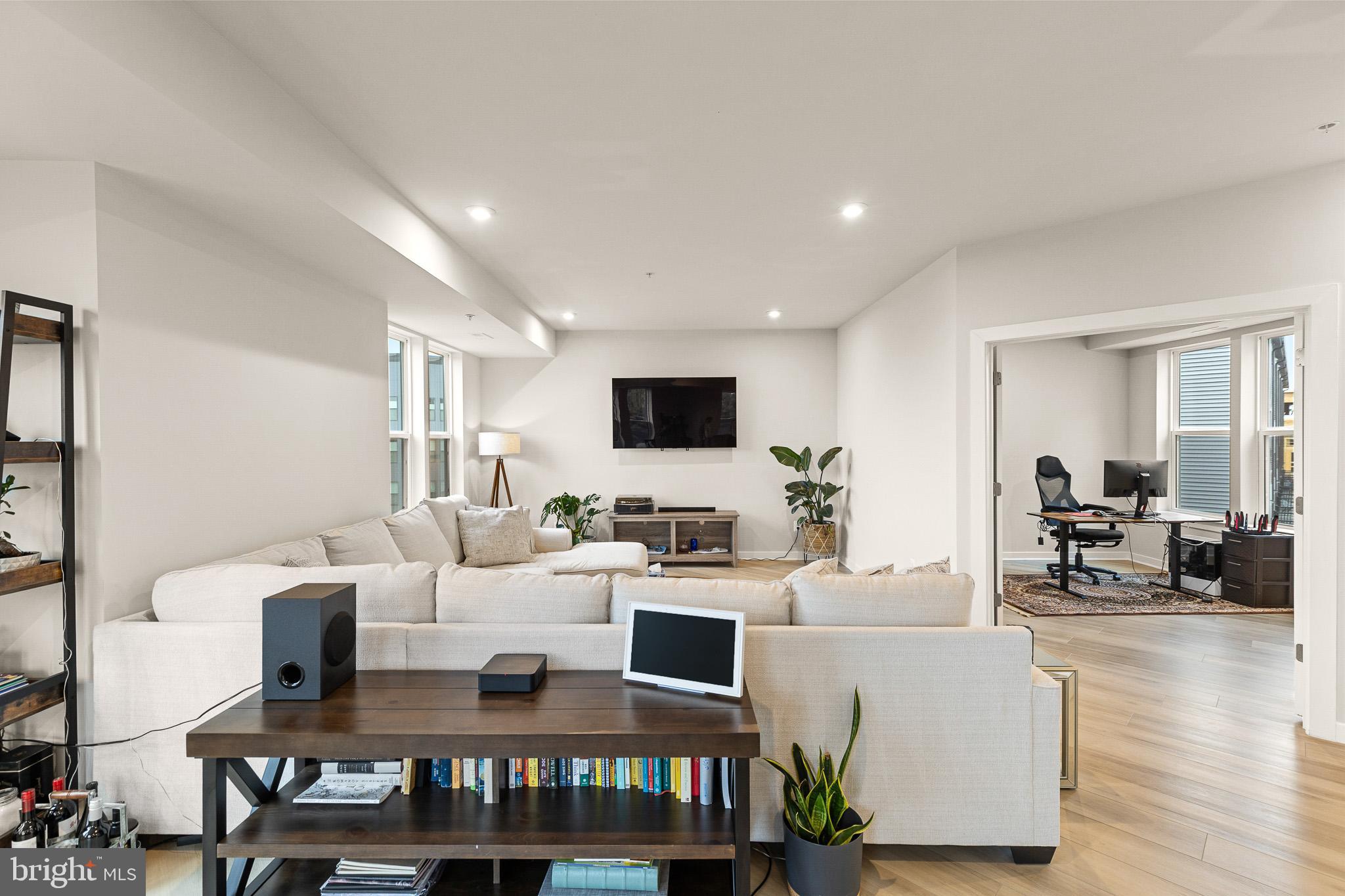 43769 Transit Square Ashburn, VA 20147 - Photo 11 of 36 a living room with a flat screen tv and a table