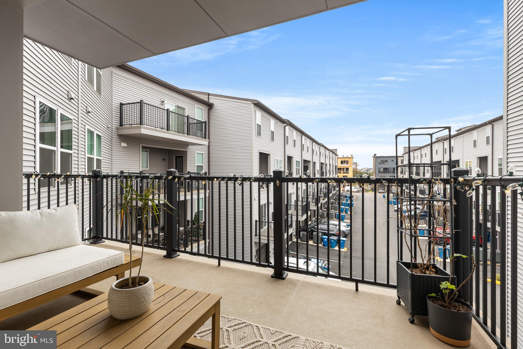 43769 Transit Square Ashburn, VA 20147 - Photo 16 of 36 a balcony with wooden floor and outdoor space