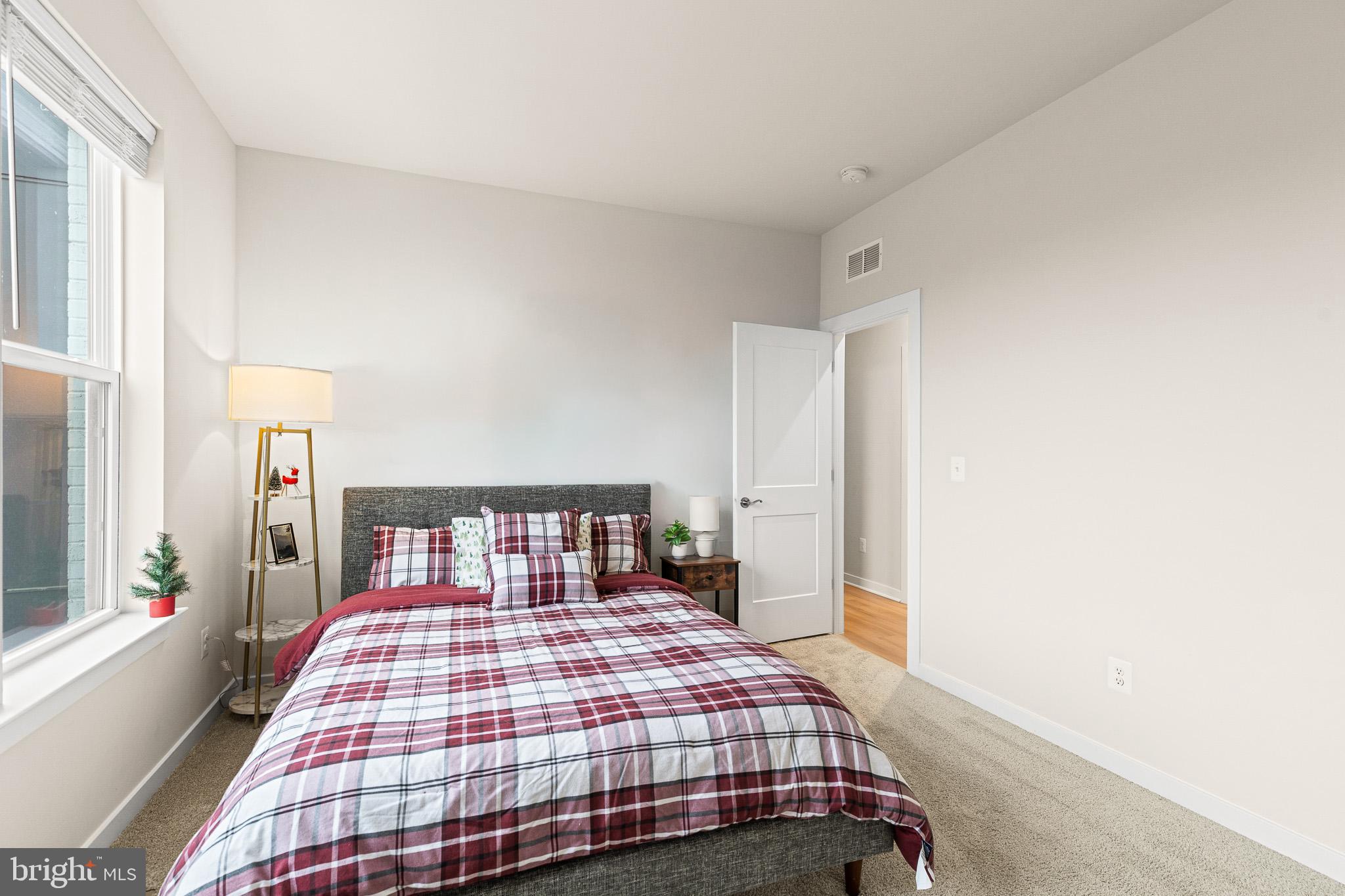 43769 Transit Square Ashburn, VA 20147 - Photo 18 of 36 a bedroom with a bed and wooden floor