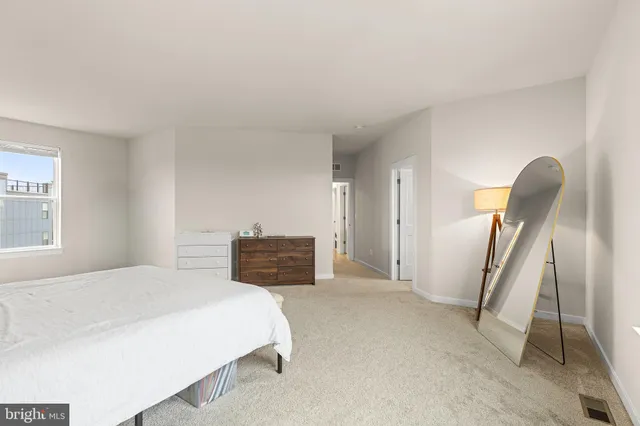 a bedroom with a bed and dresser