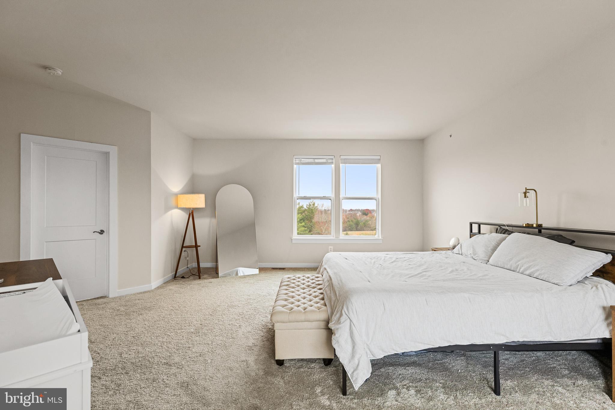 43769 Transit Square Ashburn, VA 20147 - Photo 22 of 36 a bedroom with a bed and a chair