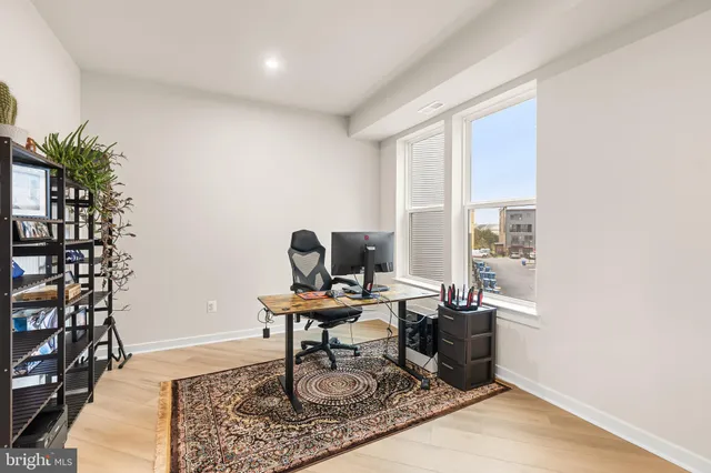 a work room with furniture and a potted plant