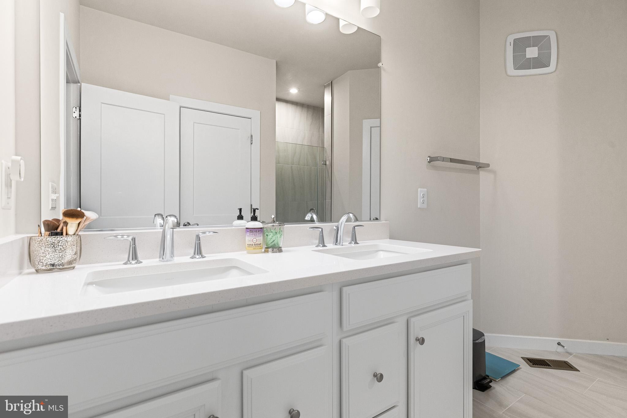 43769 Transit Square Ashburn, VA 20147 - Photo 24 of 36 a bathroom with a sink and a mirror