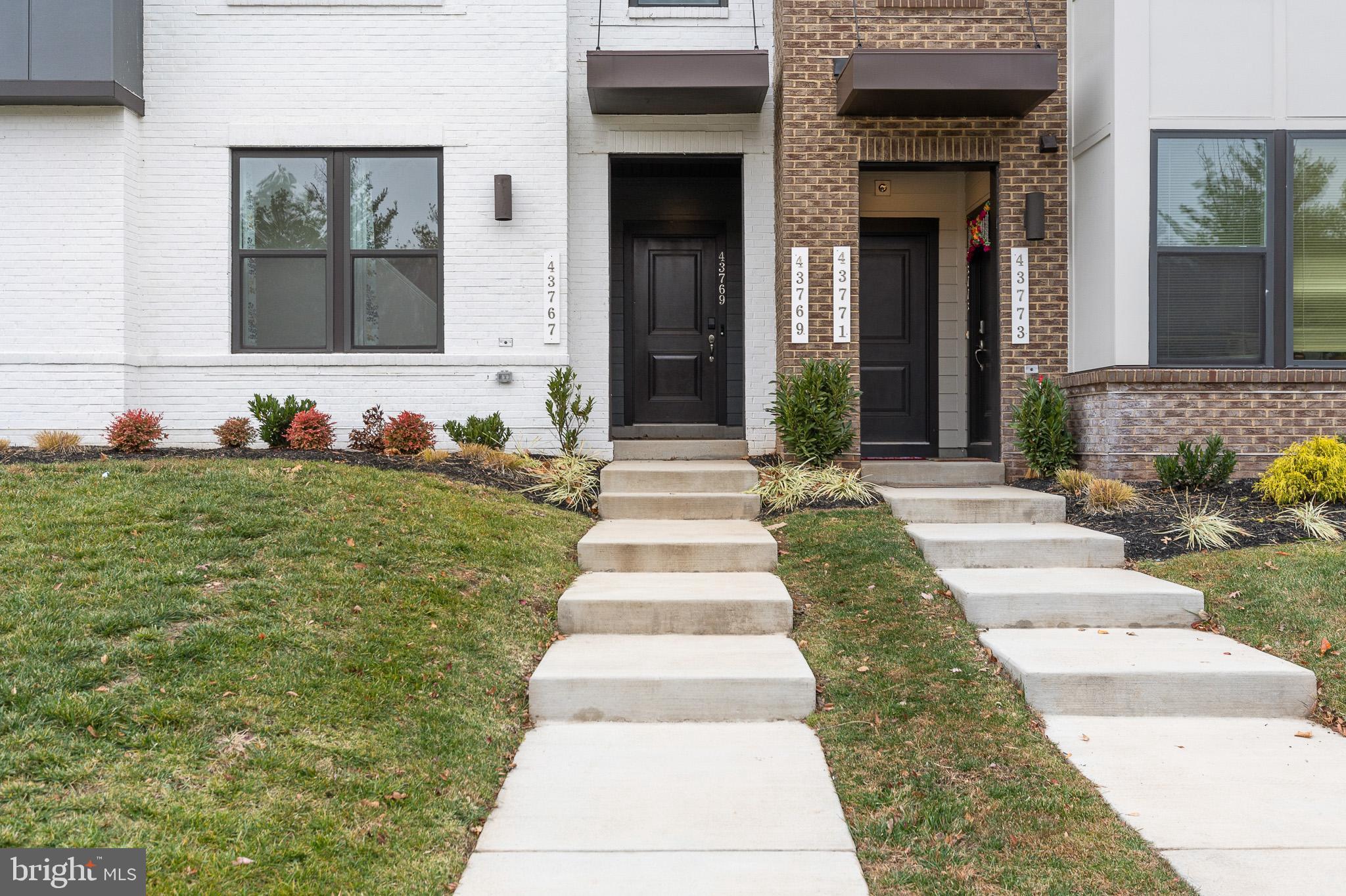 43769 Transit Square Ashburn, VA 20147 - Photo 33 of 36 a front view of a house with a yard and plants