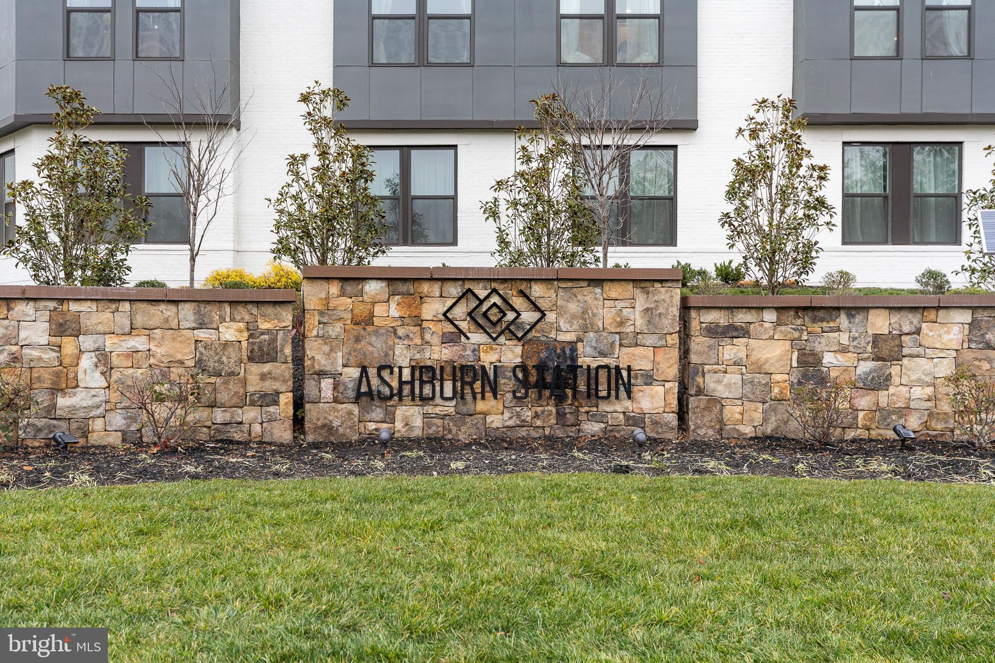 43769 Transit Square Ashburn, VA 20147 - Photo 34 of 36 front view of brick building with a yard