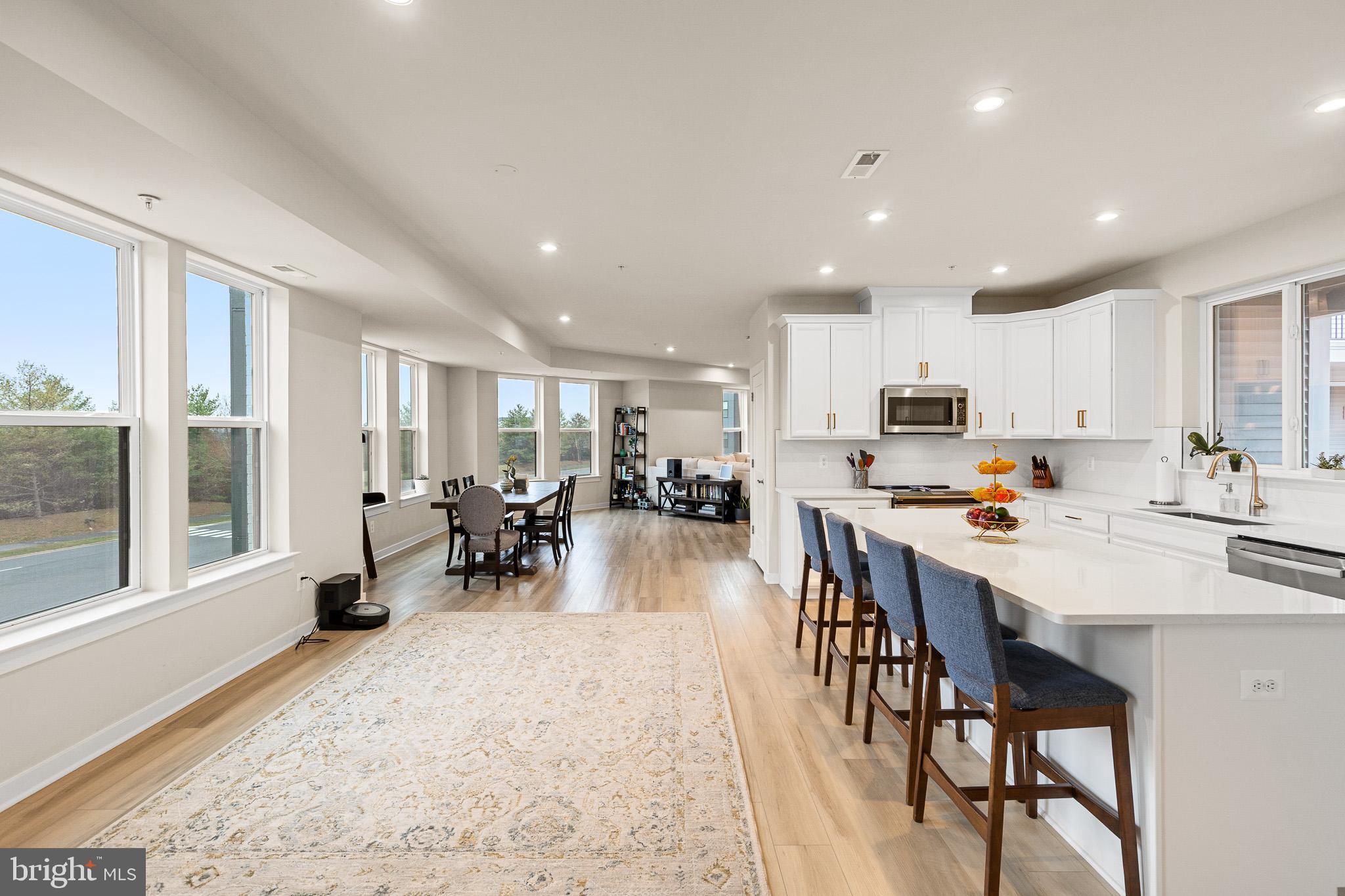 43769 Transit Square Ashburn, VA 20147 - Photo 4 of 36 a living room with stainless steel appliances furniture a dining table and chairs