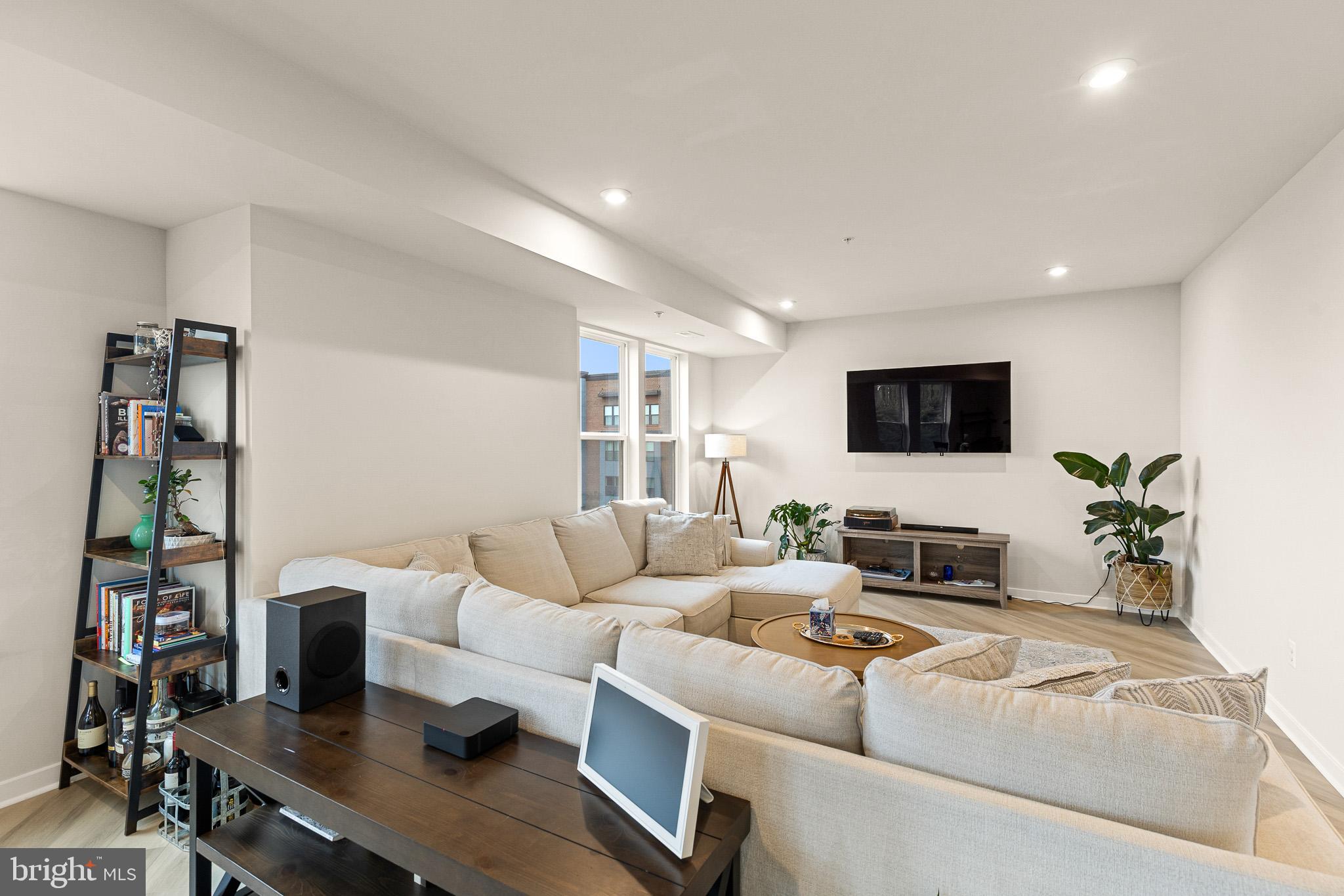 43769 Transit Square Ashburn, VA 20147 - Photo 5 of 36 a living room with furniture and a flat screen tv
