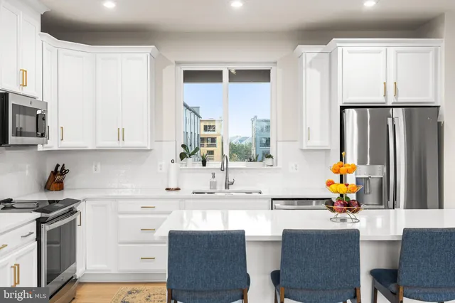 a kitchen with stainless steel appliances granite countertop a sink and cabinets