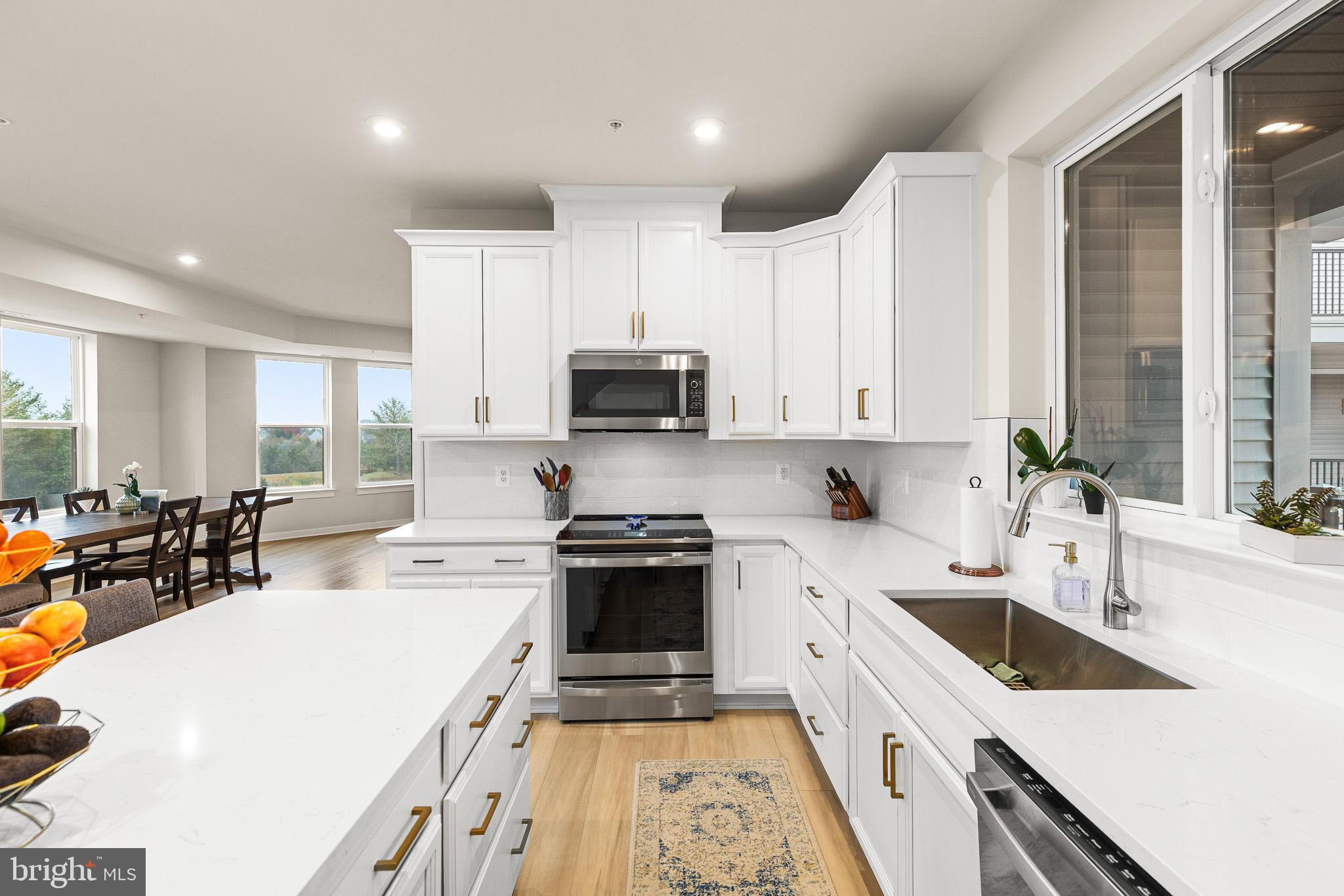 43769 Transit Square Ashburn, VA 20147 - Photo 8 of 36 a kitchen with a sink a stove and cabinets