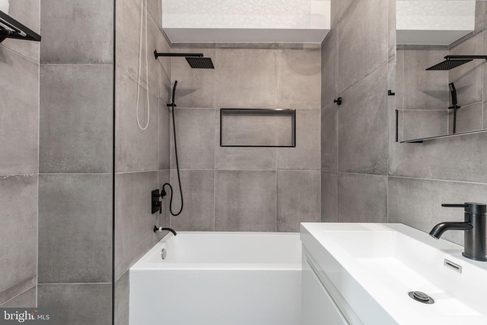 1733 Carpenter Street, Unit D Philadelphia, PA 19146 - Photo 27 of 37 a bathroom with a tub and a sink