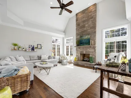 a living room with furniture wooden floor and a fireplace