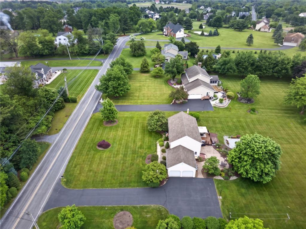 853 Lahr Road Nazareth, PA 18064 - Photo 22 of 29 An aerial perspective reveals a verdant landscape with homes nestled amidst mature trees and meticulously manicured lawns.