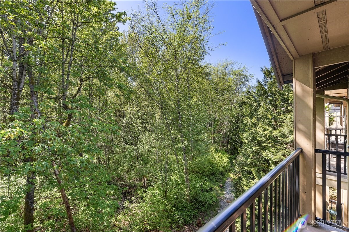 18930 Bothell Everett Highway, Unit B303 Bothell, WA 98012 - Photo 7 of 20 a view of a balcony with a tree