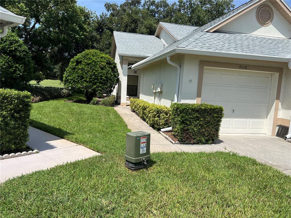 9108 Bassett Lane, Unit B New Port Richey, FL 34655 - Photo 2 of 66 a view of a house with a yard