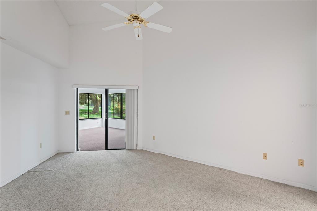 9108 Bassett Lane, Unit B New Port Richey, FL 34655 - Photo 22 of 66 a view of a room with a ceiling fan and a window